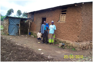 Pastor Emmanuel and his family outside of his house
